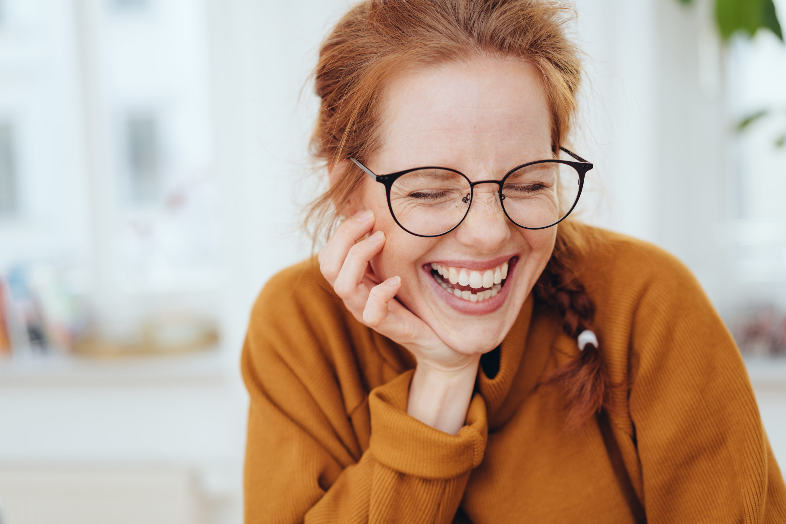 Pretty red-haired girl laughing portrait